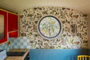 porthole window view of cherry trees